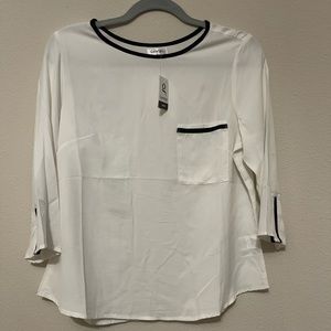 White shirt with black trim. George Brand